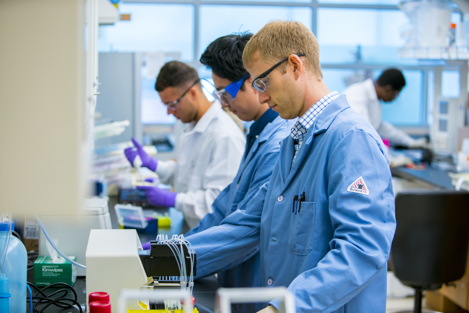 Two researchers working on a bench