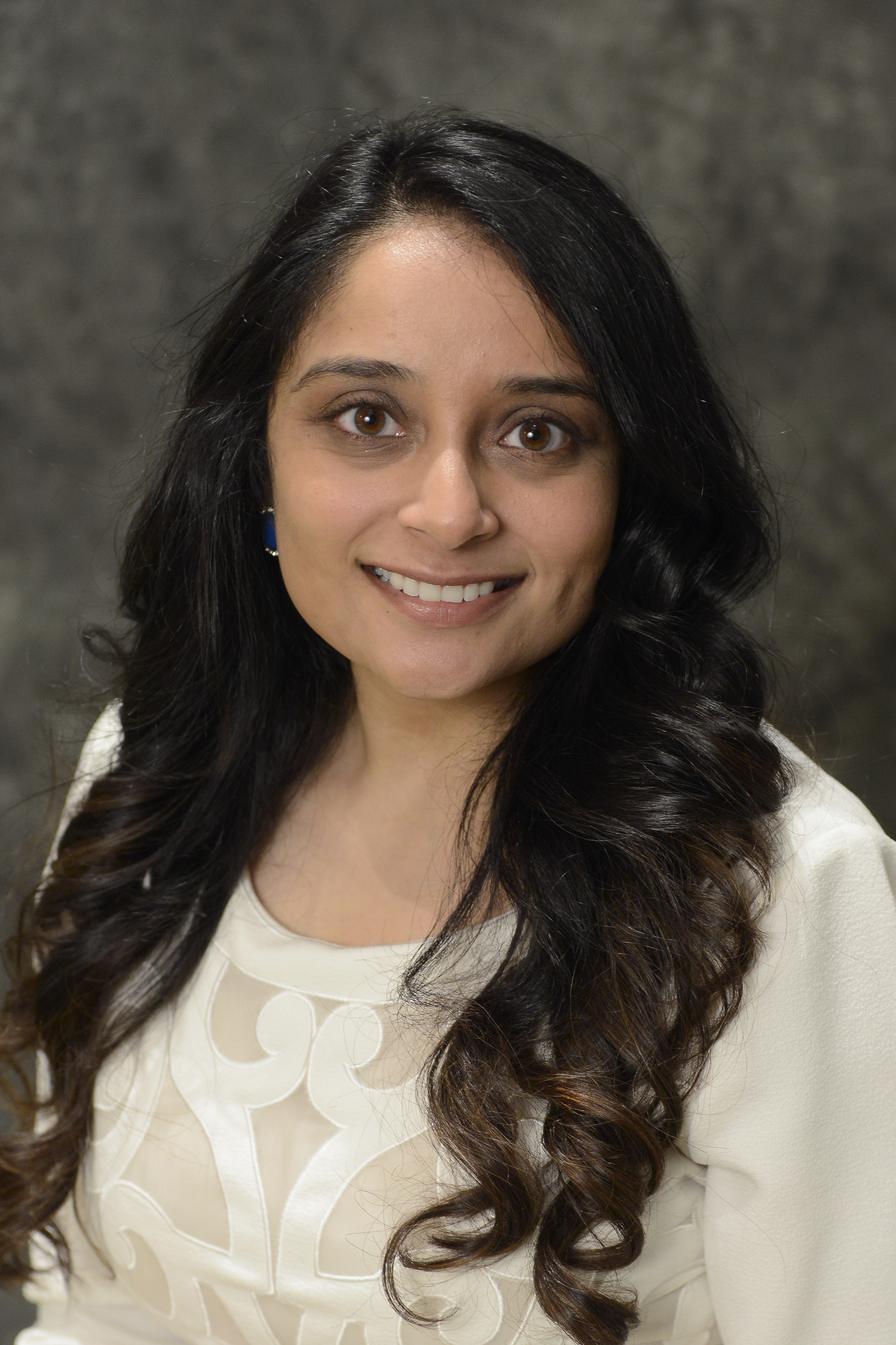 a professional headshot of Urvi Patel