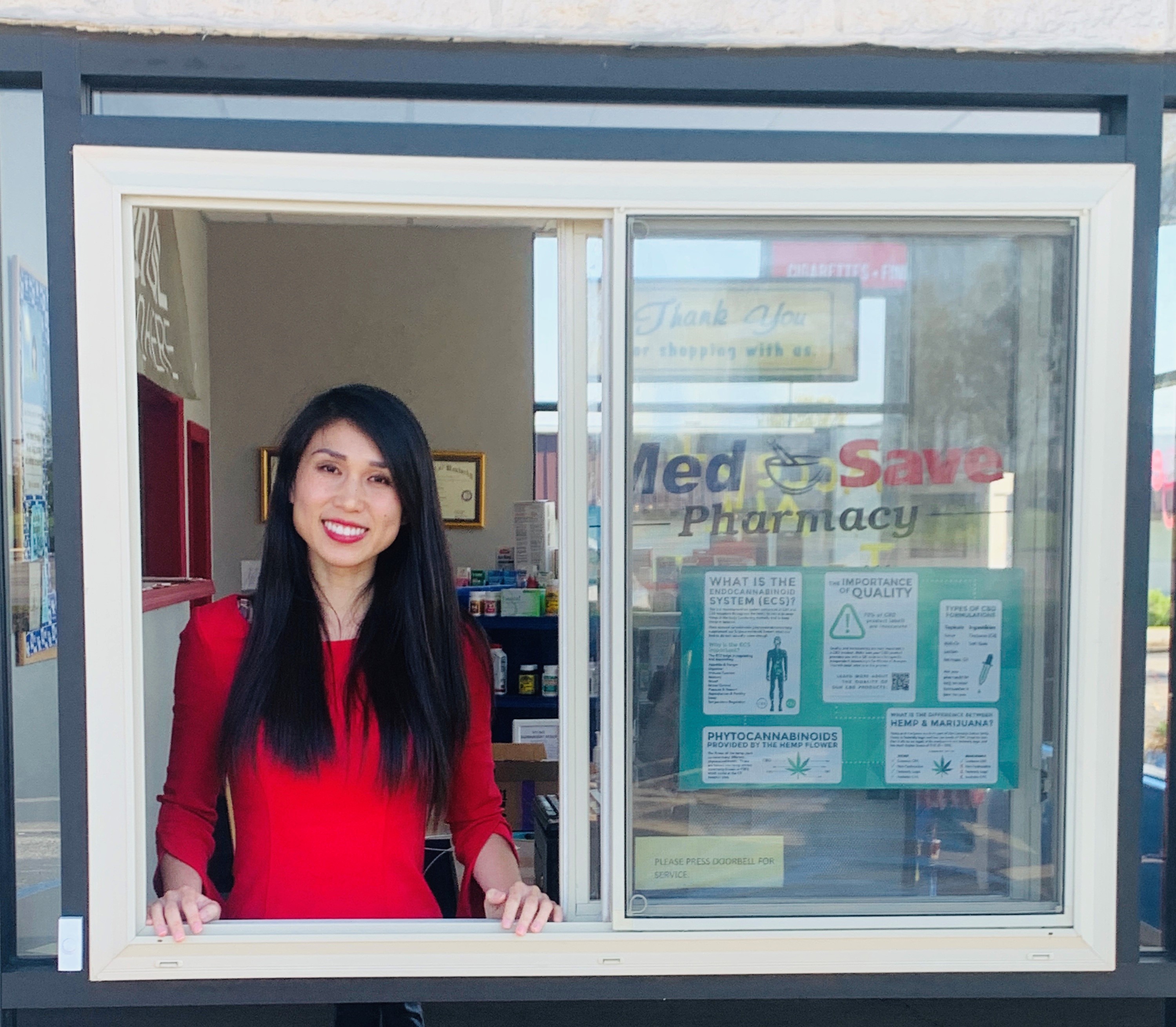 fei xiong standing at a drive through pharmacy window