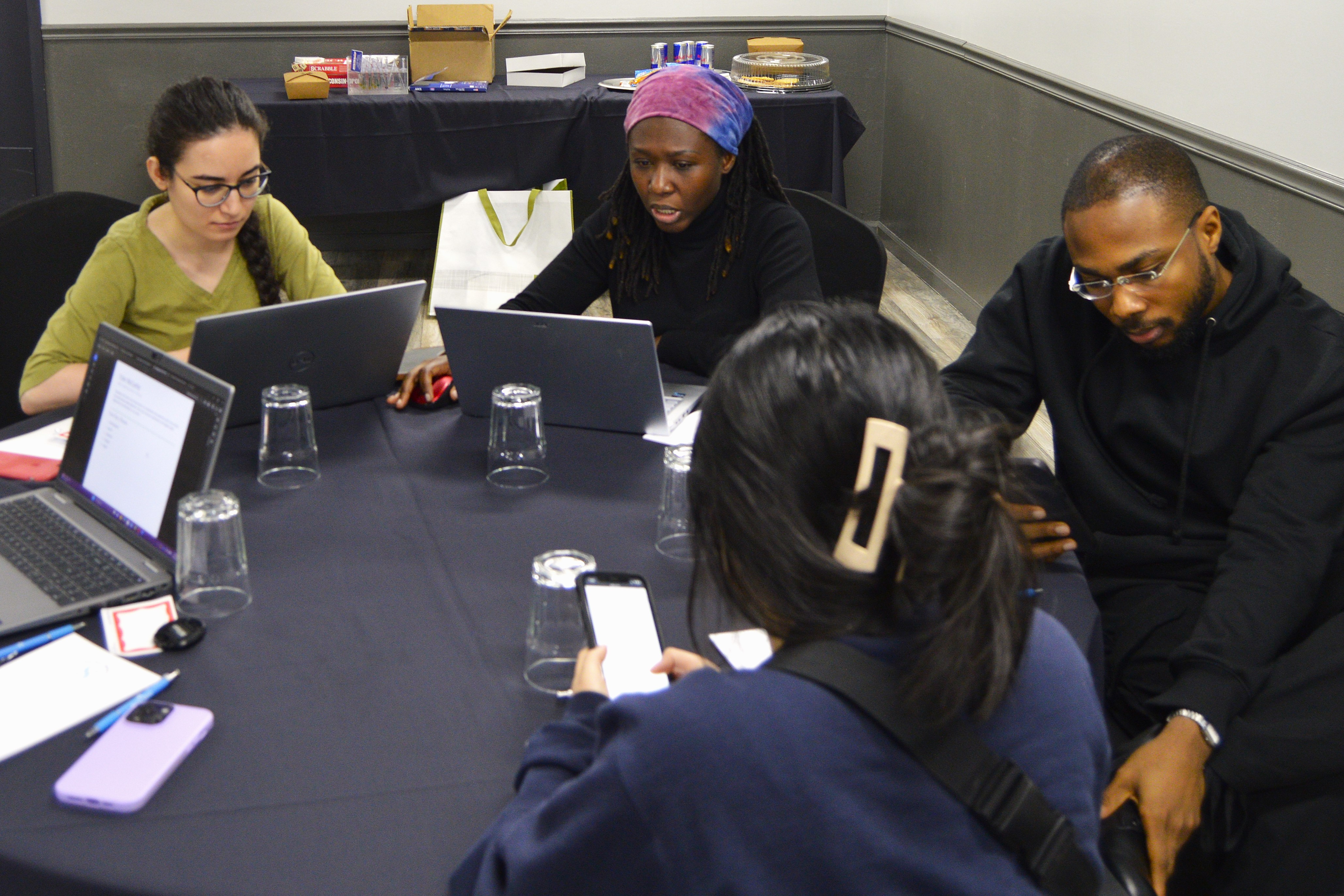 students gathering around a table, talking