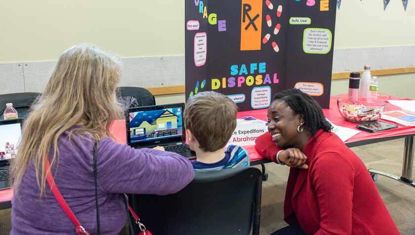 professor talking to parent and child about video game