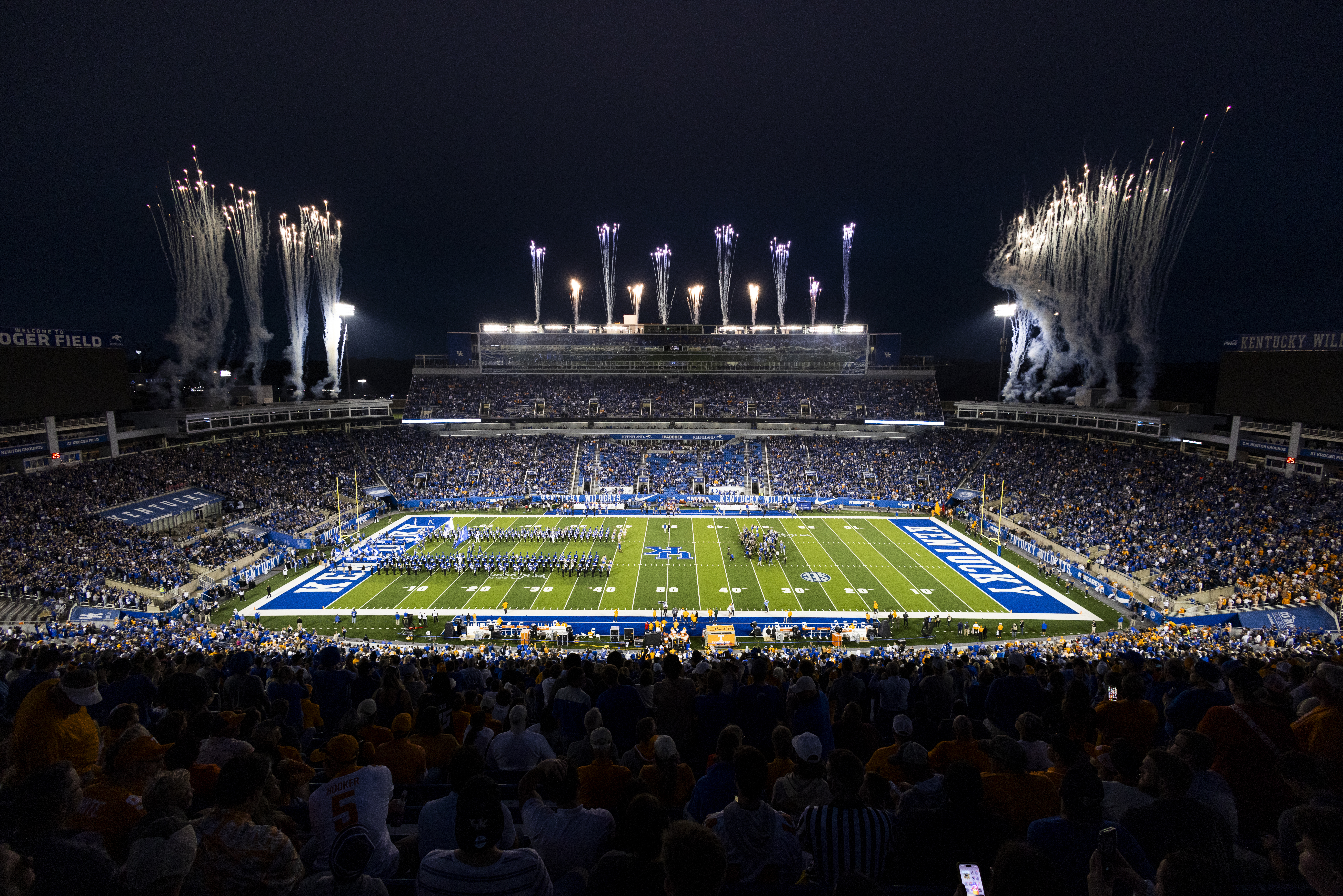 A football game at Kroger field at night with fireworks going off