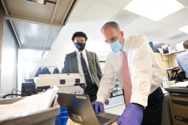 Rob Lodder, left,  and Phil Almeter are doing a drug quality study to identify impurities in injectable drugs.  They use infrared technology to detect impurities on September 29, 2020.