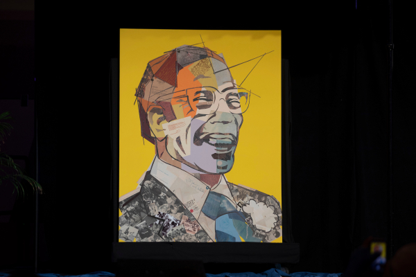 Image of a man laughing with glasses made up of colorful letters