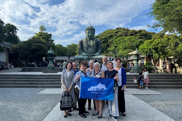 UK College of Pharmacy alumni and faculty stand together with Kitasato University colleagues in front of the Great Buddha of Kamakura during their Pharmacy Around the World trip to Japan