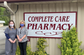 Cindi and Taylor in front of total care pharmacy sign