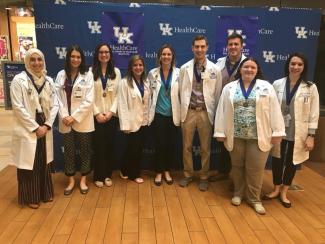 students standing together in white coats