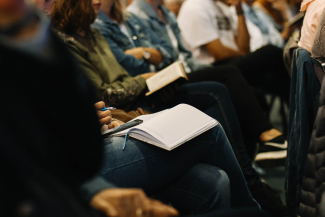 torso down view of people sitting with notebooks on lap