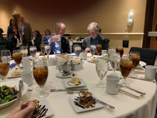 two people sitting at table eating