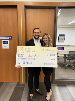 William and Abigail Burkhart pose with a check from the CEO Challenge.