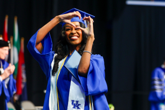 student in cap and gown at graduation