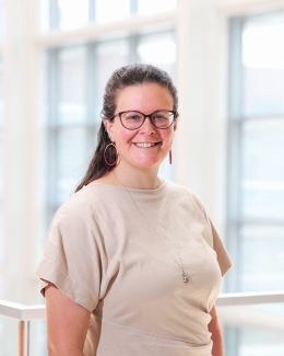 A woman wearing glasses smiling