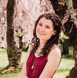 Headshot of woman standing outside in the springtime