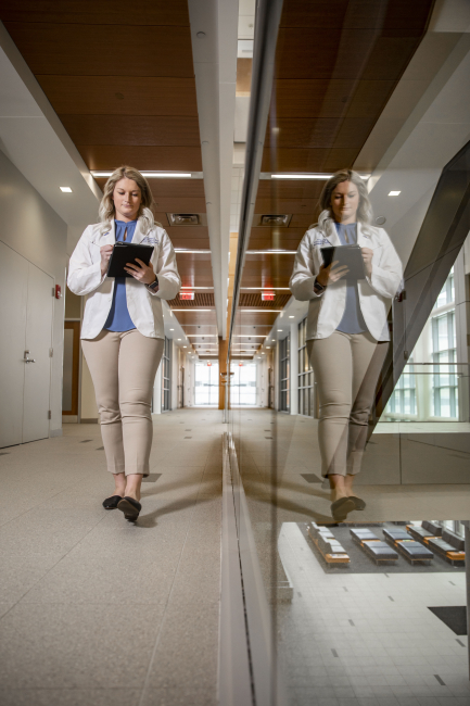 student walking in hallway with iPad