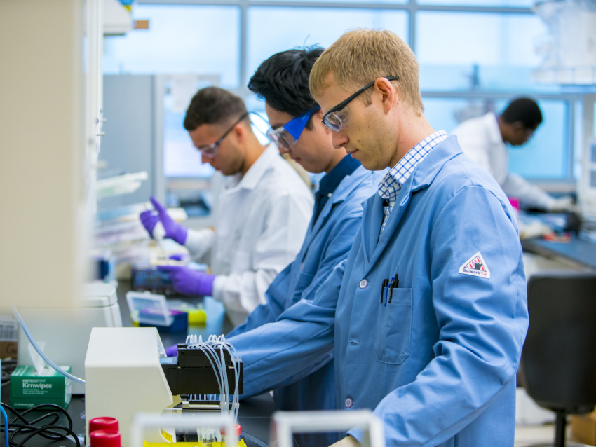 Two researchers working on a bench