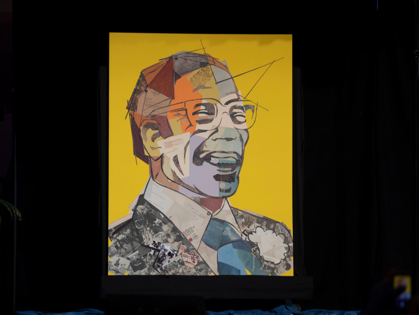 Image of a man laughing with glasses made up of colorful letters