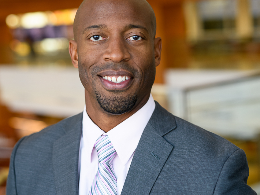 Headshot of O'Shea Hudspeth wearing a suit and tie