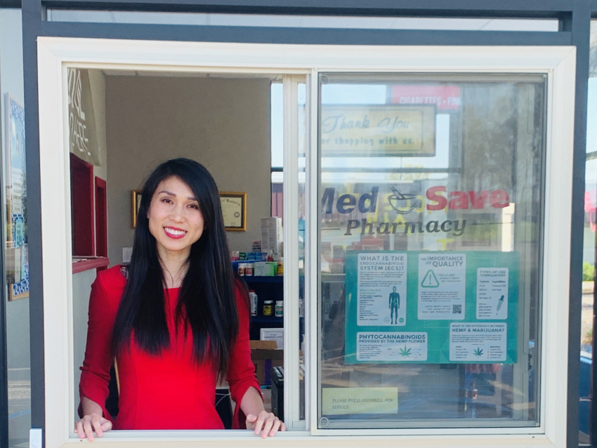fei xiong standing at a drive through pharmacy window