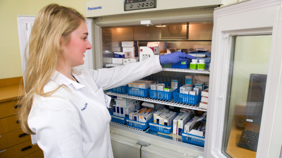 pharmacist looking into medication fridge