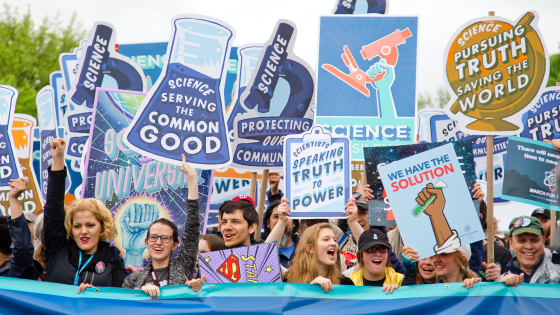 Science supporters at march with signs
