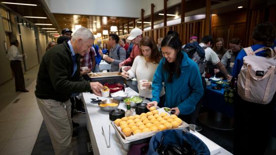 students and faculty at buffet of chili and cornbread