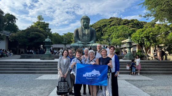 UK College of Pharmacy alumni and faculty stand together with Kitasato University colleagues in front of the Great Buddha of Kamakura during their Pharmacy Around the World trip to Japan