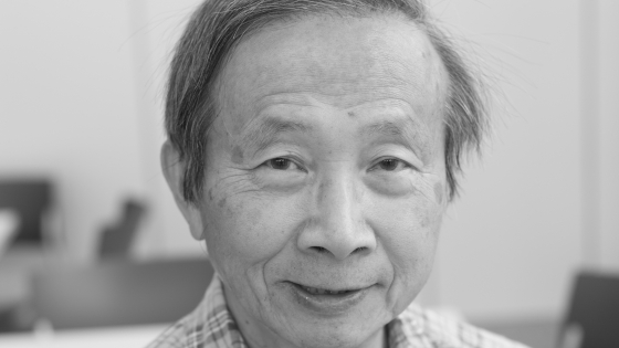 A man wearing a collared shirt smiling at the camera