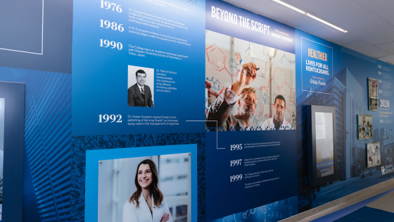 A blue history wall with an interactive screen and milestones 