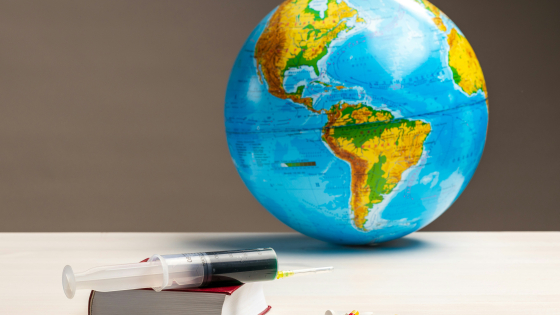 a globe, a syringe, some pills and a book