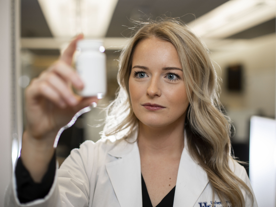 Student Pharmacist with Pill Bottle