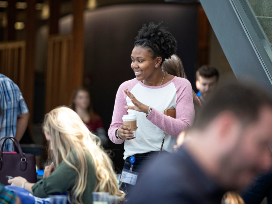 student waving at friends