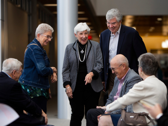 residency alumni laughing in atrium