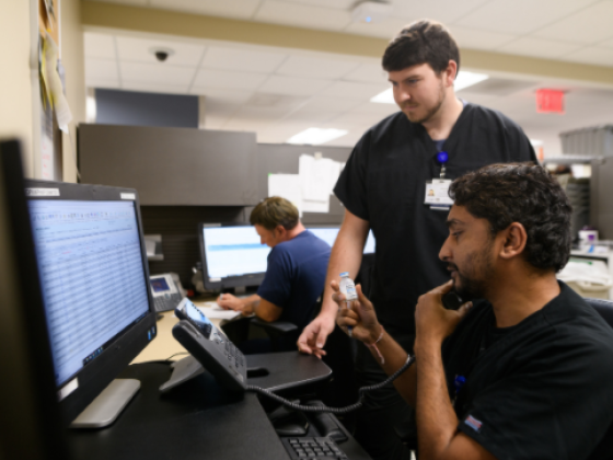 pharmacists in front of computer looking up medication