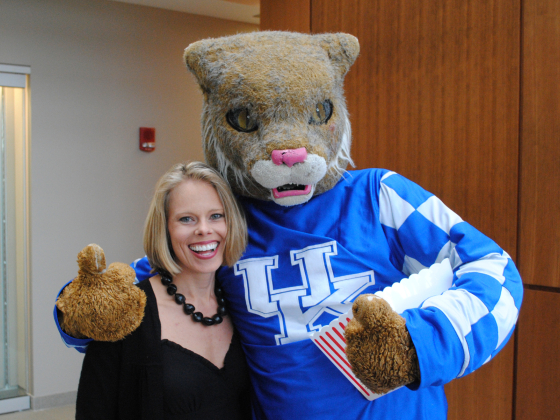 Wildcat with woman giving thumbs up to camera