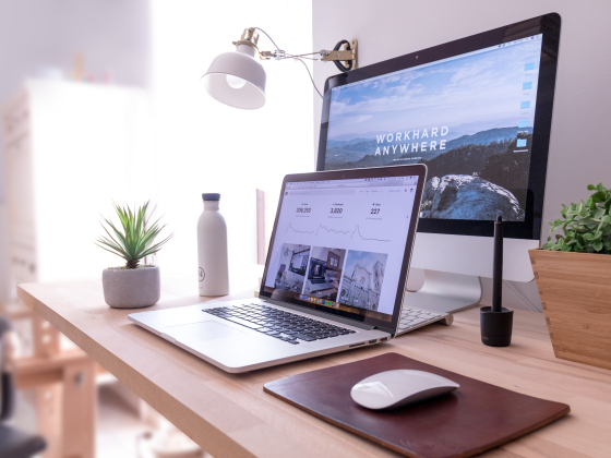 laptop in front of larger computer monitor