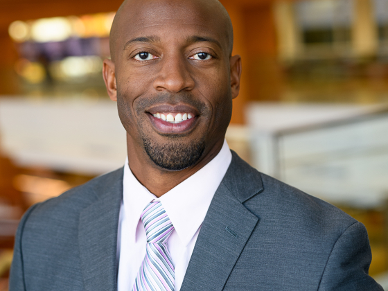 Headshot of O'Shea Hudspeth wearing a suit and tie