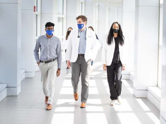 pharmacy students in masks walking down hallway