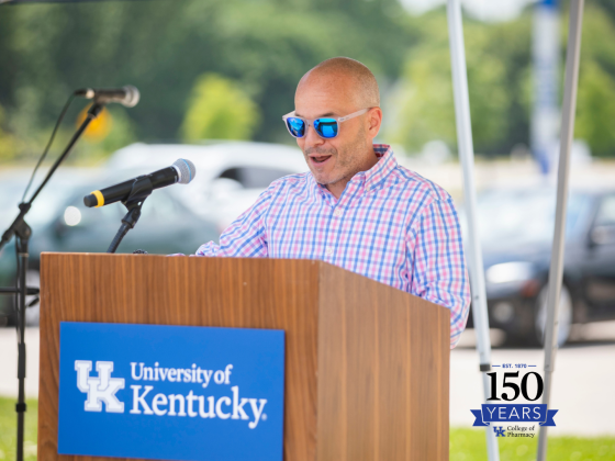 frank romanelli speaking at a podium outside