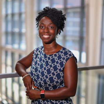 Woman leaning on railing smiling