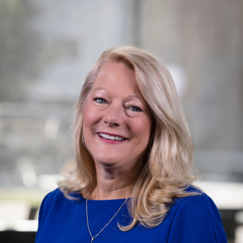 woman wearing blue smiling