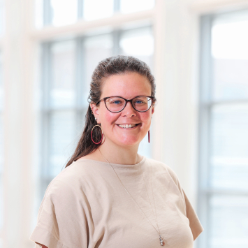 A woman wearing glasses smiling