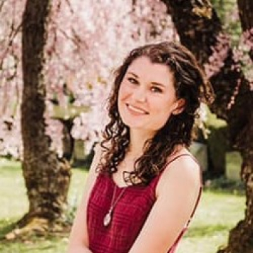 Headshot of woman standing outside in the springtime