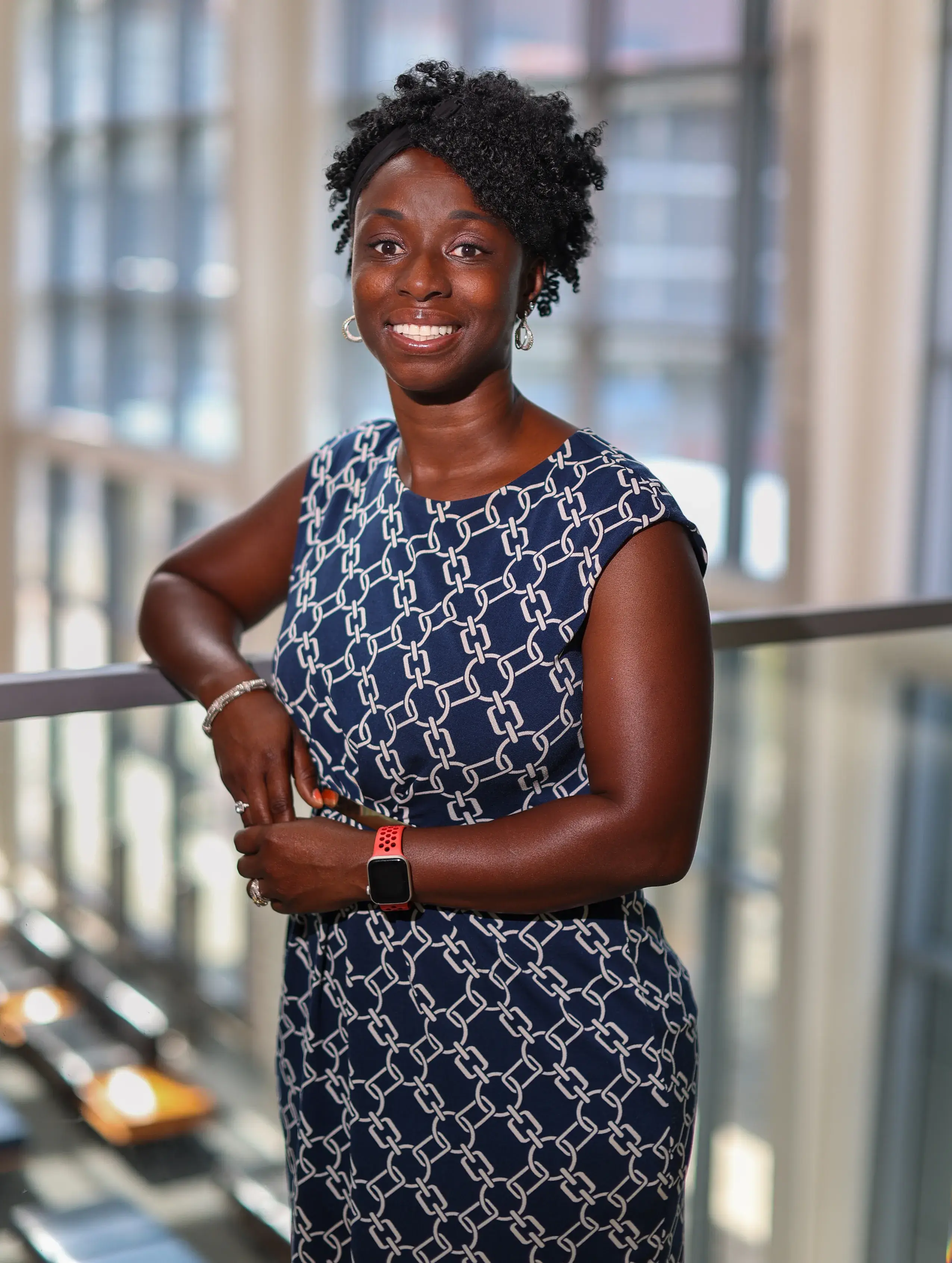 Woman leaning on railing smiling