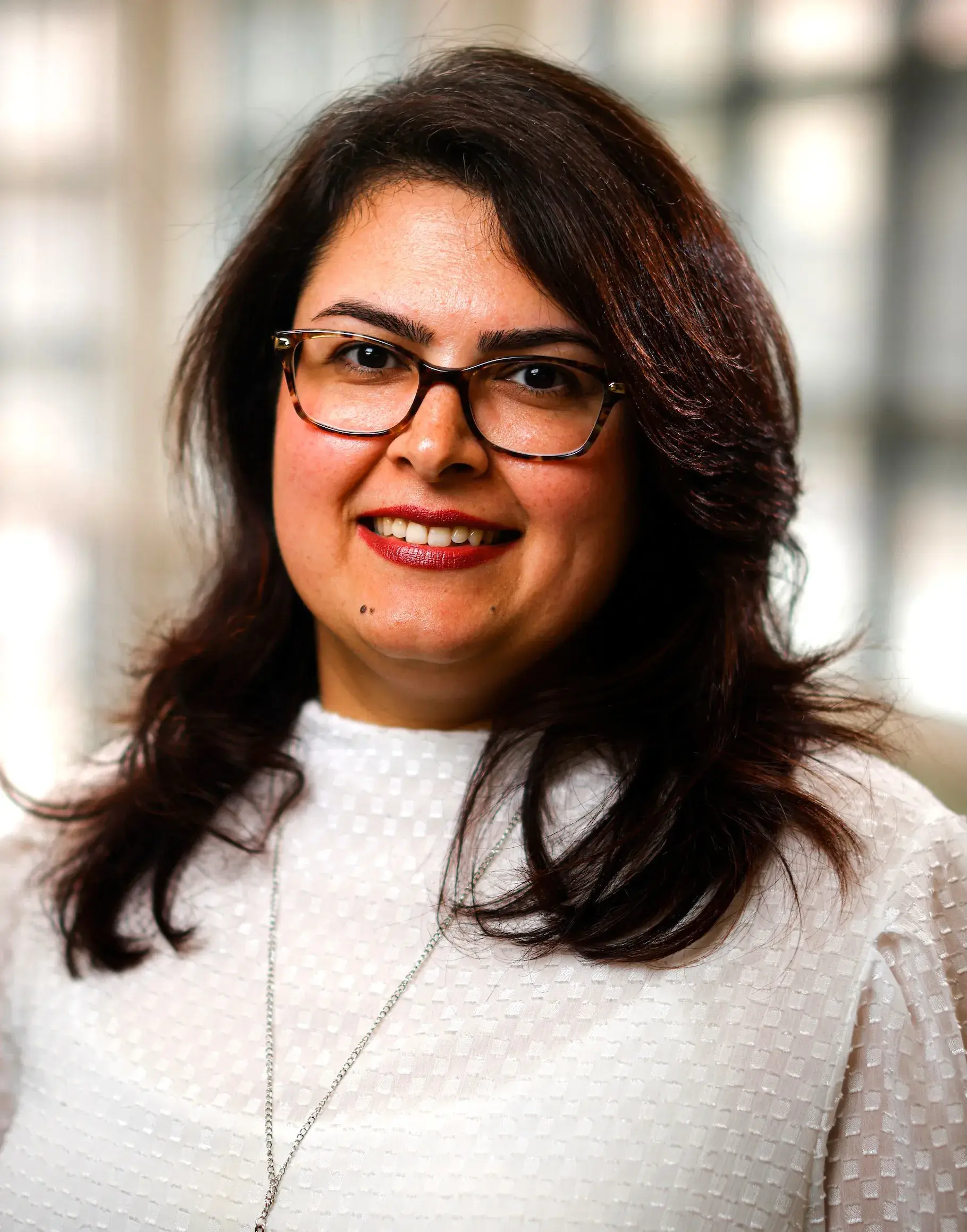 woman wearing glasses and smiling