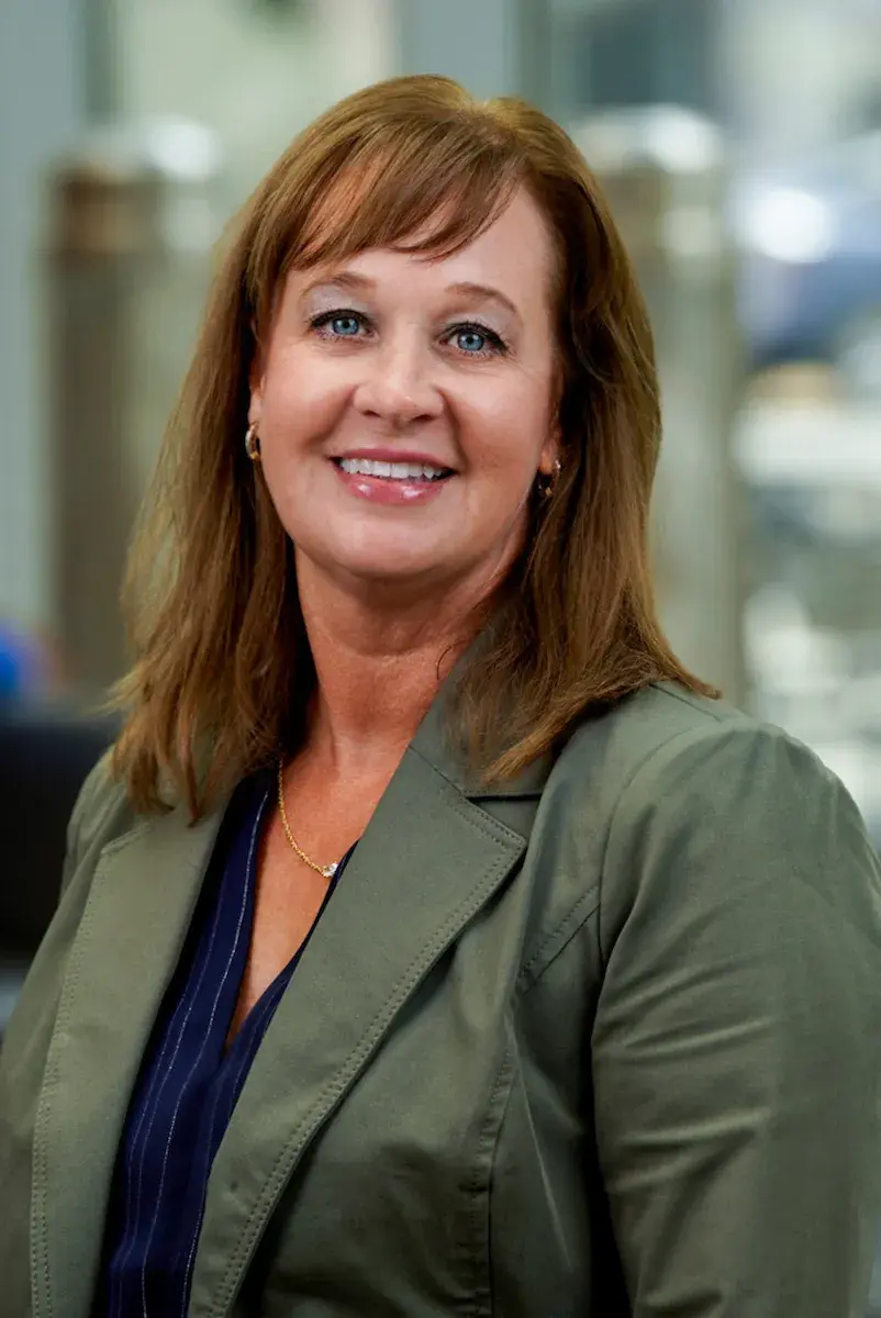Woman in green jacket smiling