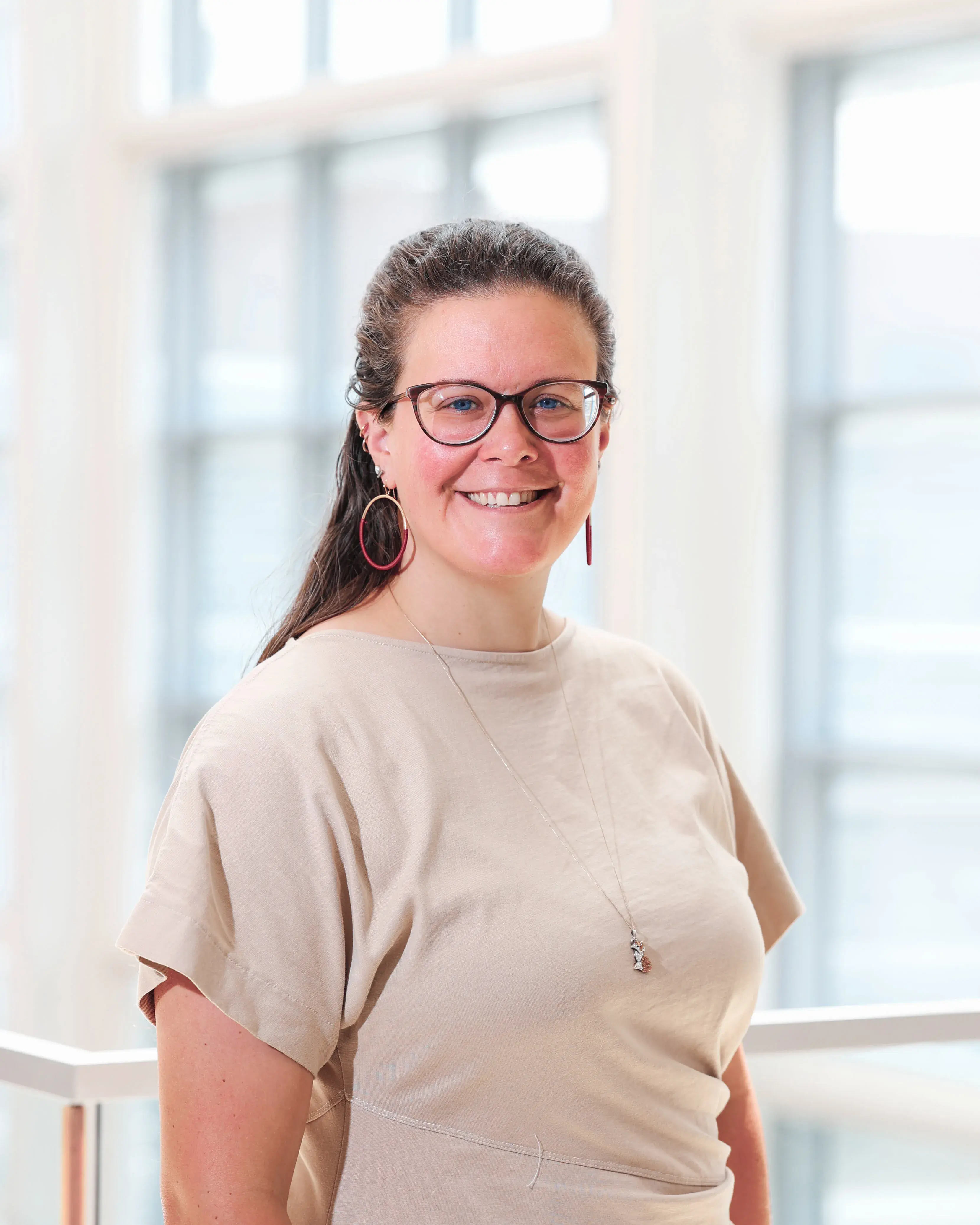 A woman wearing glasses smiling